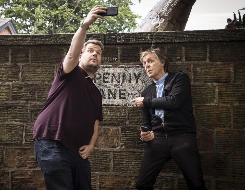 In this image released by CBS, Paul McCartney, right, joins host James Corden as they take a selfie on Penny Lane during the "Carpool Karaoke" segment on "The Late Late Show with James Corden." Their visit to McCartney’s hometown of Liverpool had many fans crying sweet tears of nostalgia. (Craig Sugden/CBS via AP)