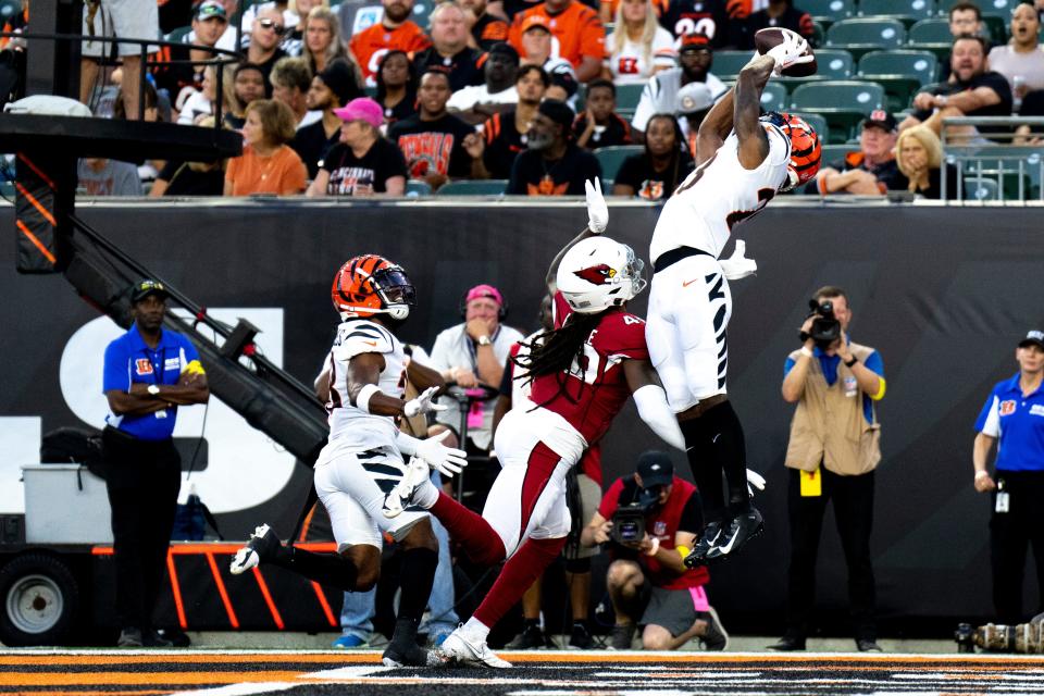 Aug 12, 2022; Cincinnati, Ohio, USA; Cincinnati Bengals safety Dax Hill (23) attempts to make an interception over Arizona Cardinals tight end Chris Pierce Jr. (49) in the first half of the NFL preseason game between the Cincinnati Bengals and the Arizona Cardinals at Paycor Stadium. Mandatory Credit: Albert Cesare-USA TODAY Sports