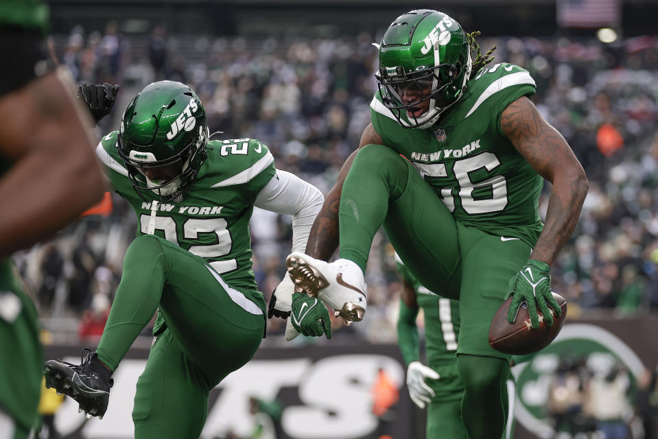 New York Jets linebacker Quincy Williams (56) celebrates with safety Tony Adams (22) after intercepting a pass against the Washington Commanders during the third quarter of an NFL football game, Sunday, Dec. 24, 2023, in East Rutherford, N.J. (AP Photo/Adam Hunger)