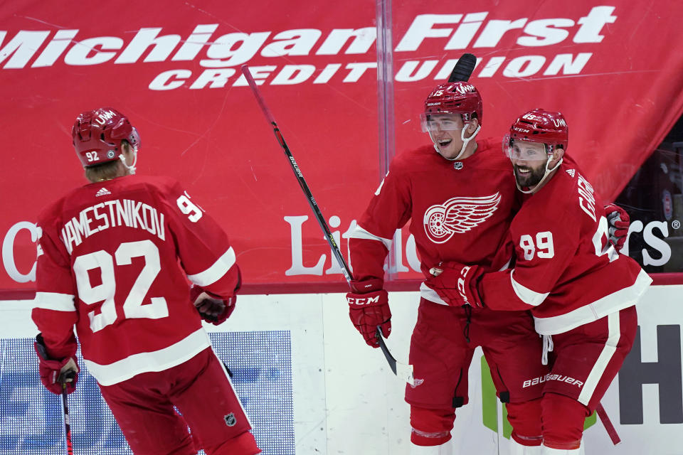 Detroit Red Wings forward Jakub Vrana, second from right, is greeted by centers Sam Gagner (89) and Vladislav Namestnikov (92) after a goal during the second period of the team's NHL hockey game against the Chicago Blackhawks, Thursday, April 15, 2021, in Detroit. (AP Photo/Carlos Osorio)