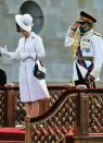 <p>Queen Elizabeth II fights a losing battle against the wind during a visit to Muscat, Oman. </p>