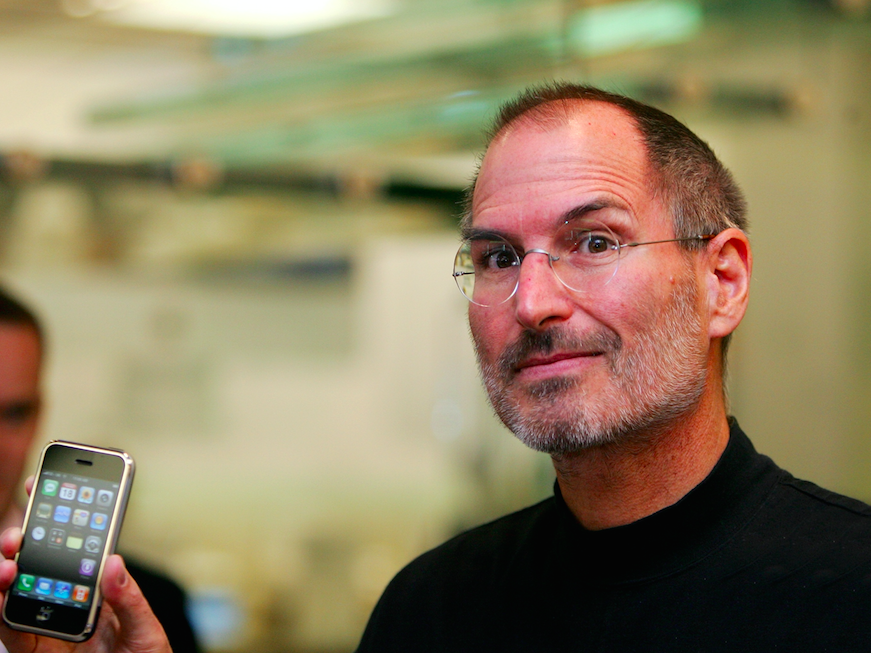 Steve Jobs holds up the original iPhone in 2007 (Picture: Rex)