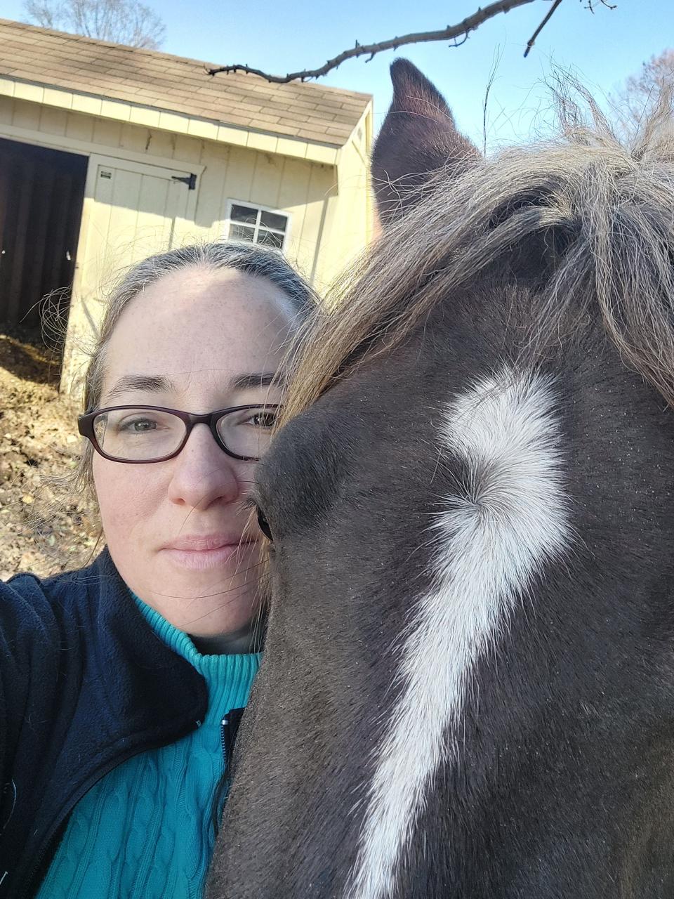 Jennifer Quail with the Chincoteague pony she purchased.