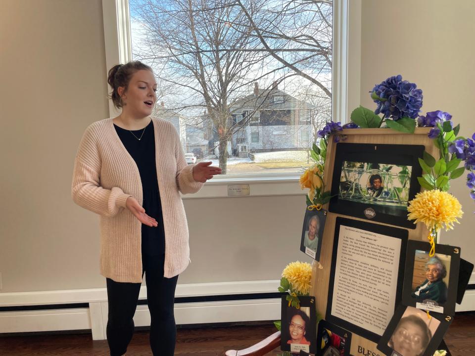 Port Huron Museum Curator of Collections and Exhibits Kayla Wendt describing one of the chairs at the new exhibit "Seat at the Table" on Feb. 2, 2024.