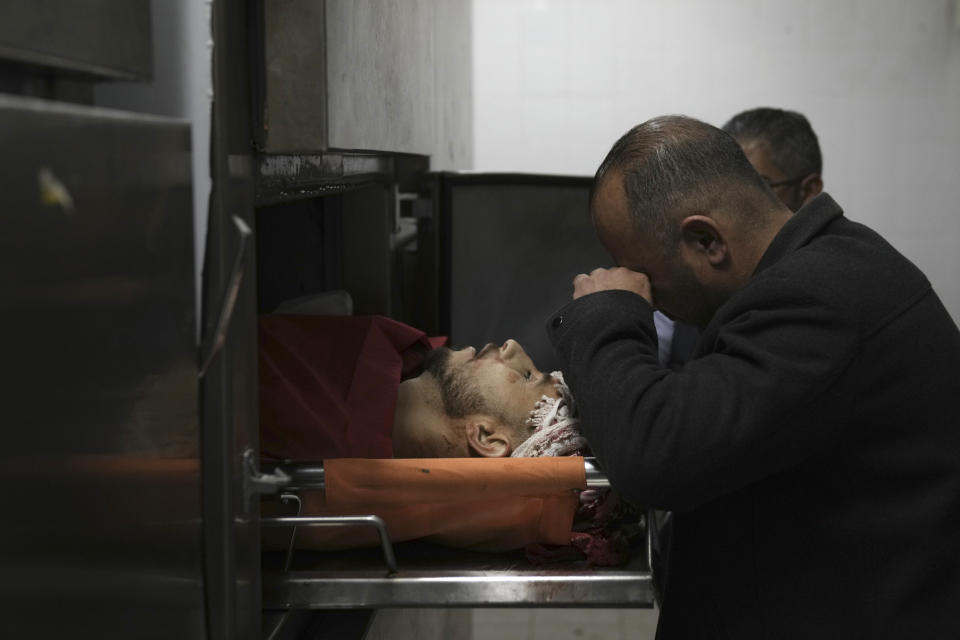 A Palestinian killed in a settler rampage lies in the morgue at the Palestine Medical Complex in the West Bank city of Ramallah, Friday, April 12, 2024. Dozens of Israeli settlers rampaged through a Palestinian village, Palestinian medics and an Israeli rights group said, killing one Palestinian and more than a dozen were wounded. Settlers stormed the village of al-Mughayyir in search of a missing 14-year-old Israeli boy, according to rights group Yesh Din.(AP Photo/Nasser Nasser)