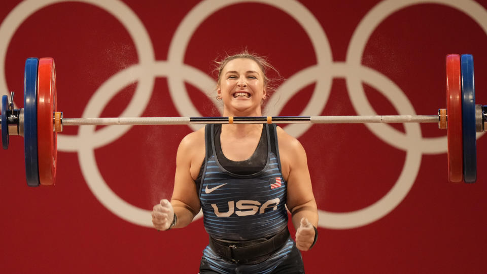 Katherine Elizabeth Nye of the United States celebrates after a lift, as she competes in the women&#39;s 76kg weightlifting event, at the 2020 Summer Olympics, Sunday, Aug. 1, 2021, in Tokyo, Japan. (AP Photo/Luca Bruno)