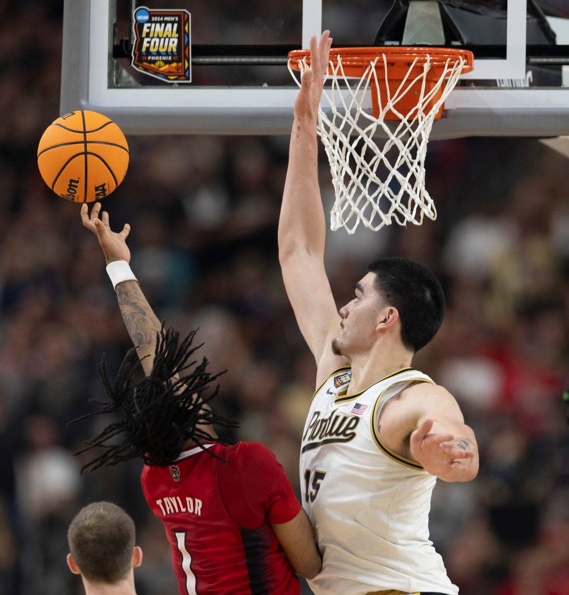 Purdue’s Zach Edey (15) blocks a set attempt by N.C. State’s Jayden Taylor (1) during the second half in the NCAA Final Four National Semifinal game on Saturday, April 6, 2024 at State Farm Stadium in Glendale, AZ. Robert Willett/rwillett@newsobserver.com
