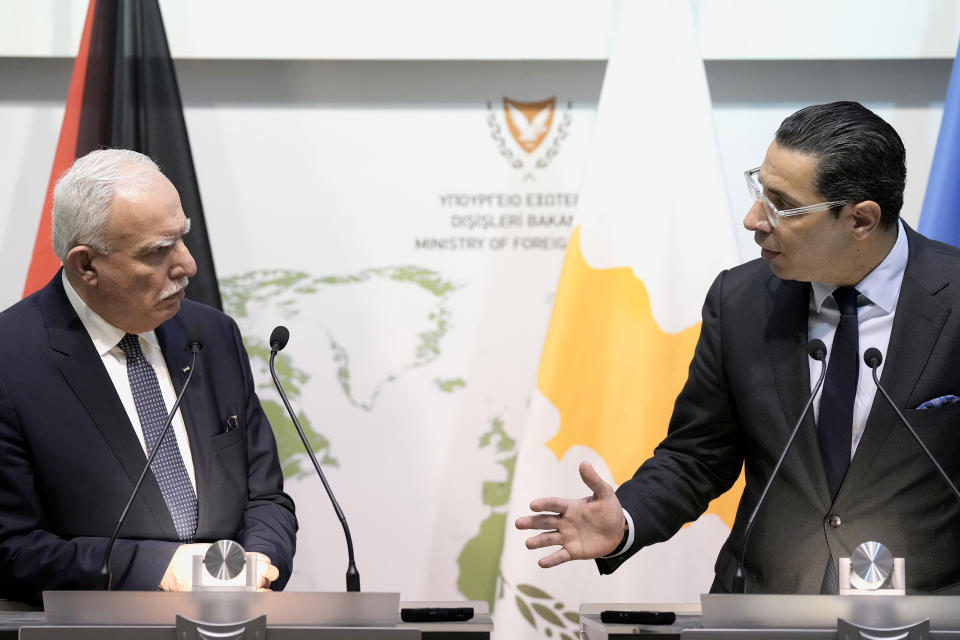 Palestinian foreign minister Riyad al-Maliki, left, and his Cyprus' counterpart Constantinos Kombos talk to the media during a press conference after their meeting at the foreign house in Nicosia, Cyprus, Wednesday, Feb. 14, 2024. Al-Maliki is in Cyprus as the east Mediterranean island nation continues to rally International support behind its initiative to set up a maritime humanitarian aid corridor to Gaza. (AP Photo/Petros Karadjias)