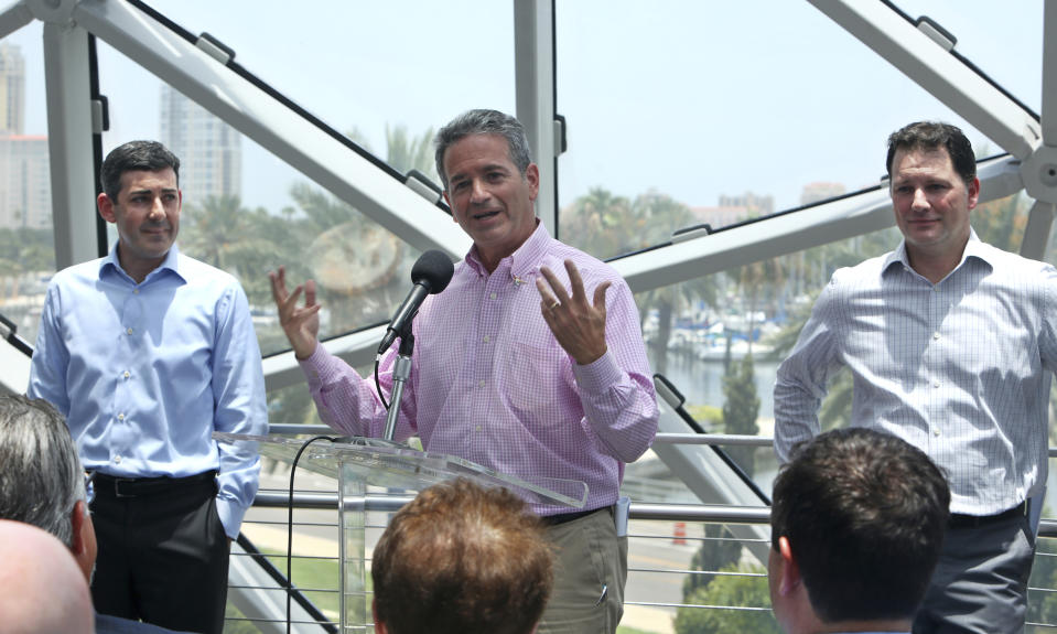 FILE - Tampa Bay Rays Principal Owner Stuart Sternberg, center, speaks at a press conference at the Dali Museum in St. Petersburg, Fla., Tuesday, June 25, 2019, about exploring the prospect of playing some future home games in Montreal. At left is Rays President of Baseball Operations Matthew Silverman, and at right is team President Brain Auld. The Tampa Bay Rays’ proposed plan to split the season between Florida and Montreal has been rejected by Major League Baseball. Rays principal owner Stuart Sternberg announced the news on Thursday, Jan. 20, 2022. (Scott Keeler/Tampa Bay Times via AP, File)