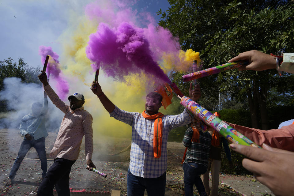 Bharatiya Janata party (BJP) supporters celebrate lead for the party in Gujarat state elections in Gandhinagar, India, Thursday, Dec. 8, 2022. Indian Prime Minister Narendra Modi’s Hindu nationalist party is all set to keep its 27-year-old control of his home Gujarat state in a record state legislature win. (AP Photo/Ajit Solanki)