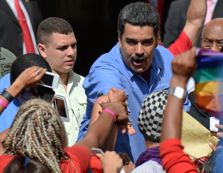 Venezuelan President Nicolas Maduro shakes hands with supporters during a rally with women in Caracas on May 24, 2016