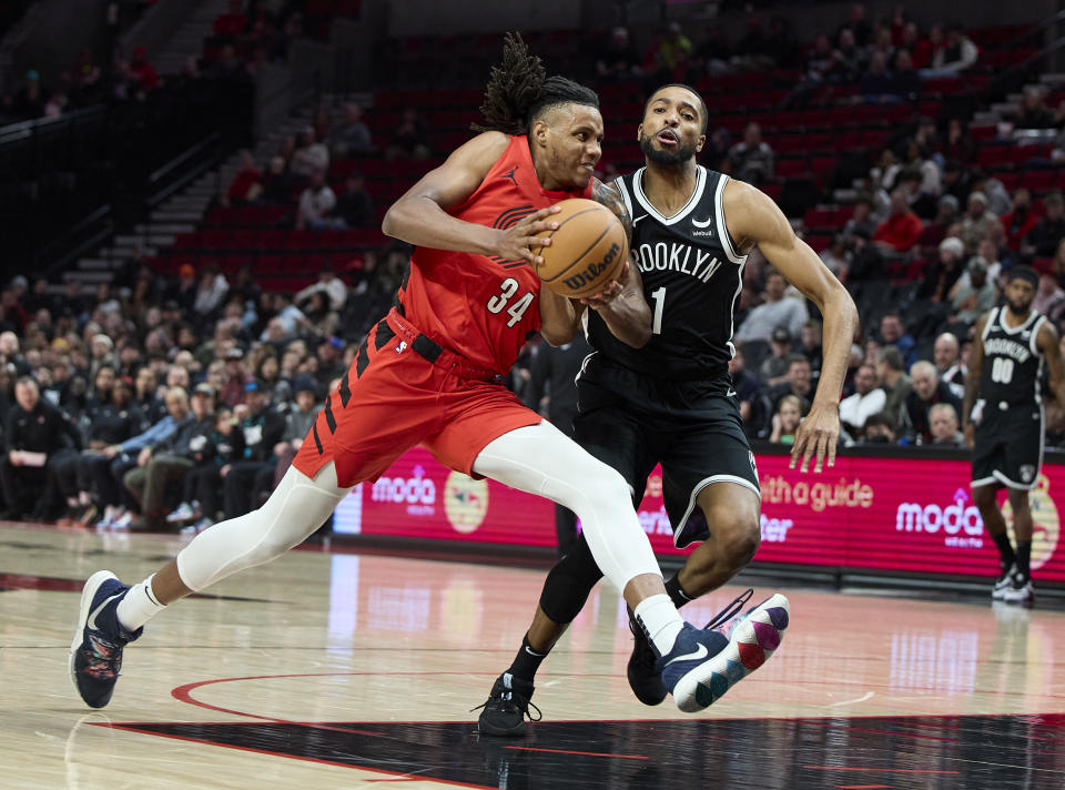 Portland Trail Blazers forward Jabari Walker drives to the basket past Brooklyn Nets forward Mikal Bridges during the first half of an NBA basketball game in Portland, Ore., Wednesday, Jan. 17, 2024. (AP Photo/Craig Mitchelldyer)