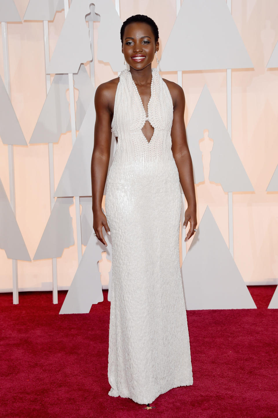 Lupita wearing a gown of all white pearls