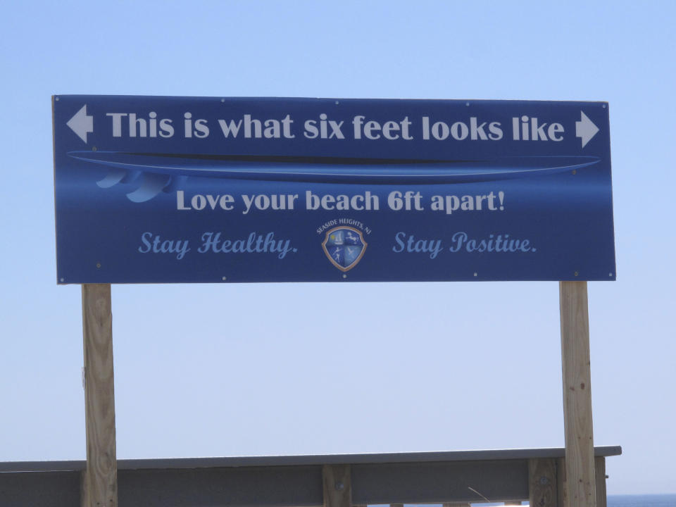 A sign on the Seaside Heights, N.J., boardwalk on May 15, 2020, advises people how far away from each other they should stay to maintain social distancing during the COVID-19 pandemic. On March 11, 2024, an independent report examining New Jersey's response to the pandemic said the state and nation were unprepared for it, adding the state is still underprepared for the next crisis. (AP Photo/Wayne Parry)