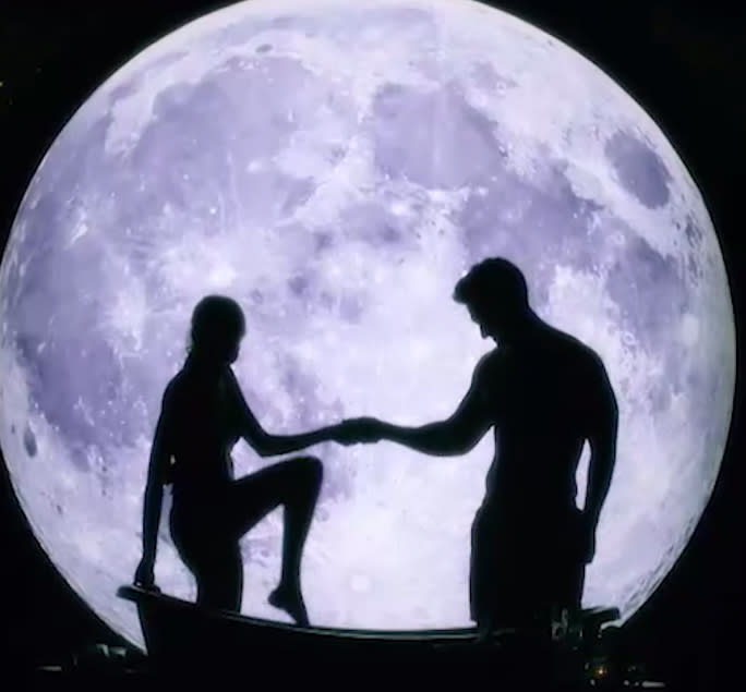 A photo from The Bachelor Australia 2019 showing a silhouette of Matt Agnew and a bachelorette getting into a bath set against a backdrop of the moon.