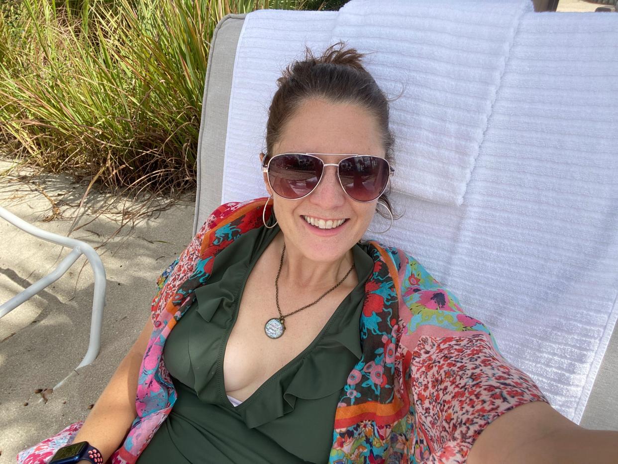 Kari lounging on a sun bed posing for a selfie at private cabana at disney's yacht club