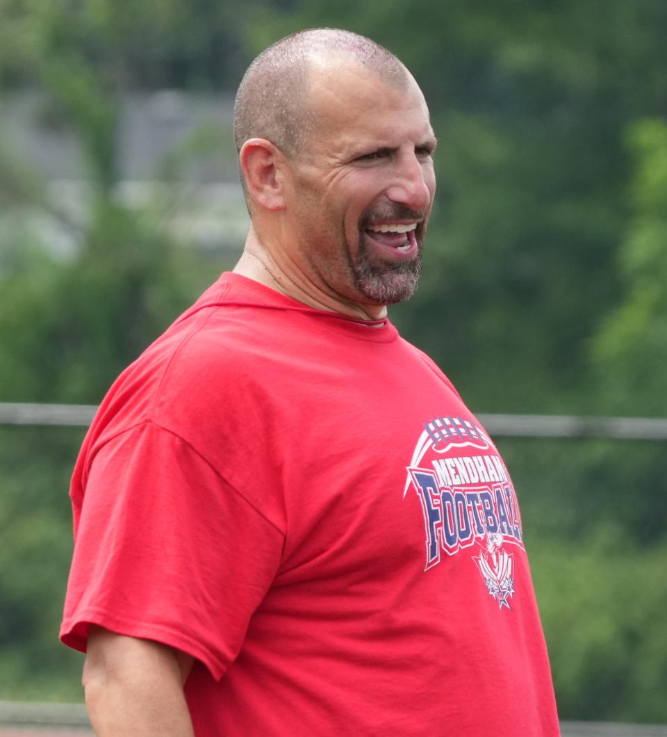 Mendham, NJ July 13, 2023 --  Ethan Jeros, Mendham coach gets his team ready for the upcoming season during their summer football practice at Mendham HS.