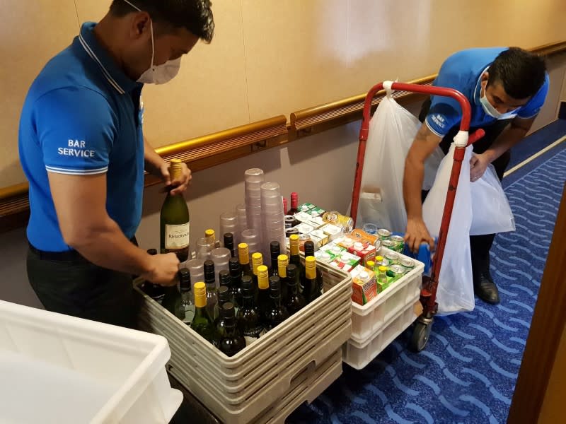 FILE PHOTO: Employees of Costa Luminosa wearing protectve masks work on a cruise ship, amid the outbreak of coronavirus disease (COVID-19)