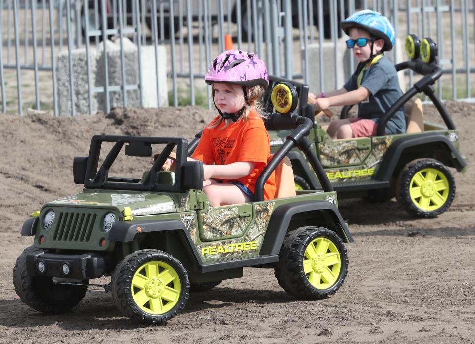 Youngsters Julia Johnson and Wyatt Cunningham drive toy Jeeps on a kid-sized course on Friday at the Jeep Beach "Main Event" at Daytona International Speedway. Julia's parents, Alex and Elizabeth Johnson, had traveled from Augusta, Georgia, to attend their first Jeep Beach. "It's a blast," Alex said. "I love it."