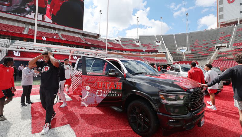 Utah Utes football players look over trucks given to them from the Crimson Collective at Rice-Eccles Stadium in Salt Lake City on Oct. 4, 2023.