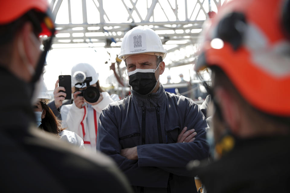 French President Emmanuel Macron likens as he visits the reconstruction site of the Notre-Dame cathedral Thursday, April 15, 2021 in Paris. Two years after a fire tore through Paris' most famous cathedral and shocked the world, French President Emmanuel Macron is visiting the building site that Notre Dame has become Thursday to show that French heritage has not been forgotten despite the coronavirus. (Benoit Tessier/Pool via AP)