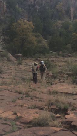 Ann Charon Rogers is escorted from a canyon floor on the White River Indian Reservation in Gila County, Arizona in this handout photo provided by the Arizona Department of Safety April 12, 2016. REUTERS/Arizona Department of Safety/Handout via Reuters