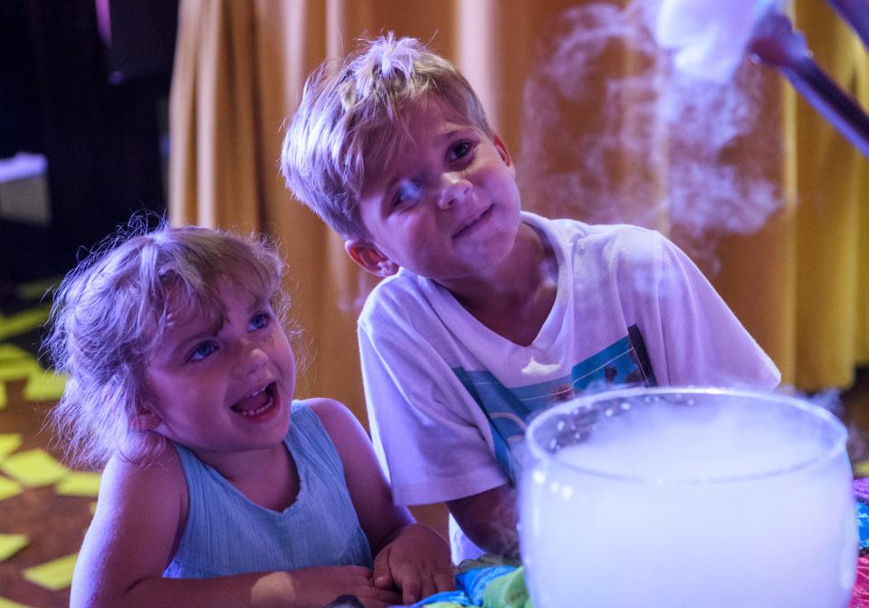 Makenna Bailey, 3, and Bryson Niehaus, 6, watch Kyle Lehmann of Brainchild Creations Community Academy pull dry ice out of a container during the Kids Comic Con at the Children's Museum of Evansville, Saturday, July 20, 2019. Lehmann made dry ice bubbles for children to pop as they visited the Brainchild Creations booth.