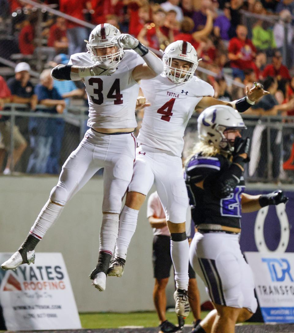 Tuttle’s Jake Tucker (34) celebrates a touchdown with Dennis Mason (4) against Bethany at SNU Stadium on Friday.