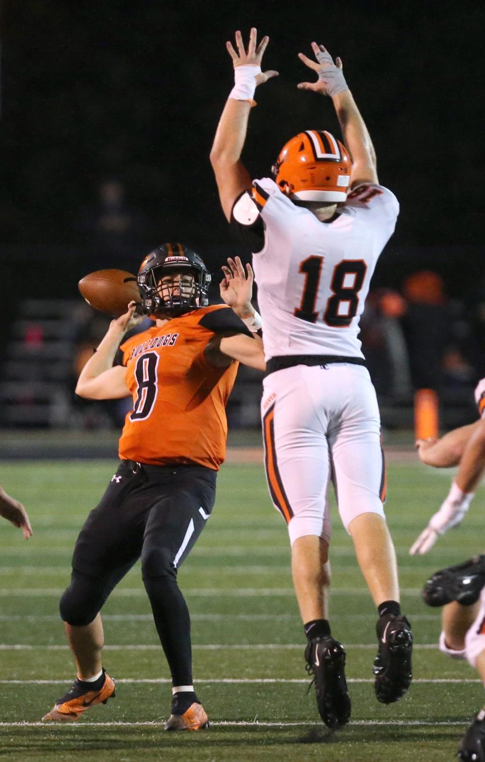 Mike Shimek, 18, of Hoover pressures Trevor Van Horn, 8, of Green during their game at Green on Friday, Oct. 15, 2021.