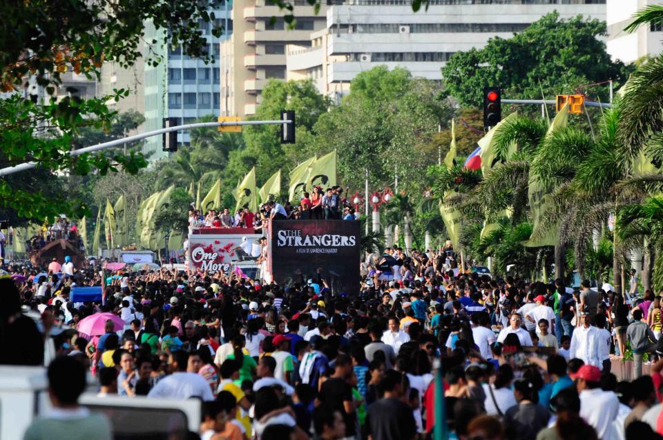 The float of the MMFF 2012 entry "The Strangers" makes its way through the crowd at the 2012 Metro Manila Film Festival Parade of Stars starting on 23 December 2012. (Angela Galia/NPPA Images)