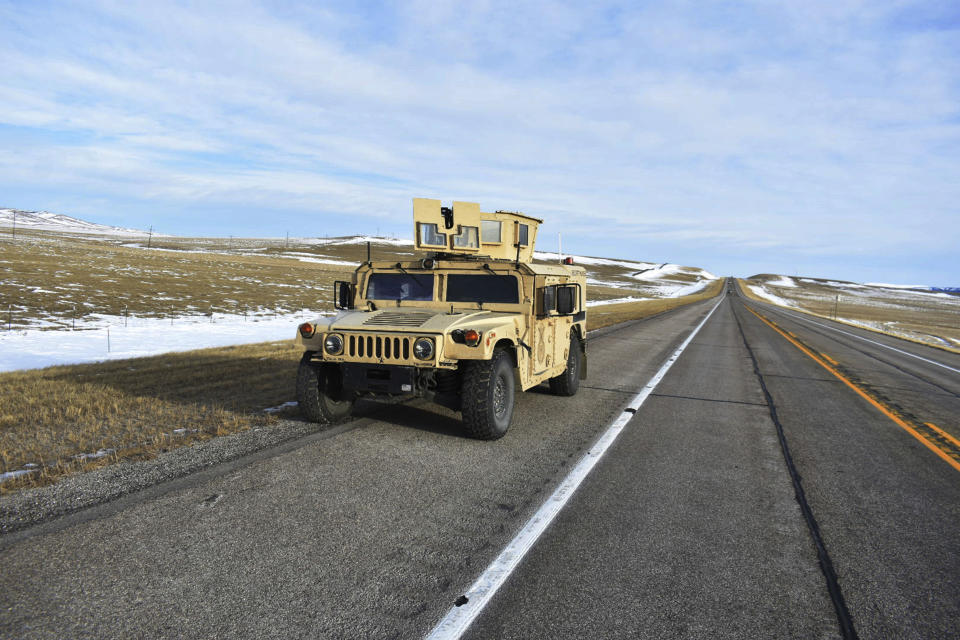 A U.S. Air Force security vehicle is seen on a central Montana highway, Tuesday, Feb 7, 2023, near Harlowton, Mont. Lawmakers in at least 11 statehouses and Congress are weighing further restrictions on foreign ownership of U.S. farmland following the balloon's journey over an area with dozens of nuclear missile silos. (AP Photo/Matthew Brown)
