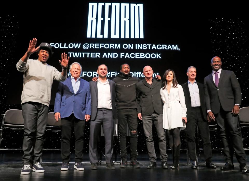 FILE - In this Jan. 23, 2019, file photo, entrepreneur and recording artist Shawn "Jay-Z" Carter, from left, gestures as he poses with New England Patriots owner Robert Kraft, Philadelphia 76ers co-owner and Fanatics executive chairman Michael Rubin, recording artist Meek Mill, Galaxy Digital CEO and founder Michael Novogratz, Brooklyn Nets co-owner Clara Wu Tsai, Third Point CEO and founder Daniel S. Loeb, and REFORM Alliance CEO and political activist Van Jones after the group announced a partnership to transform the American criminal justice system, in New York.