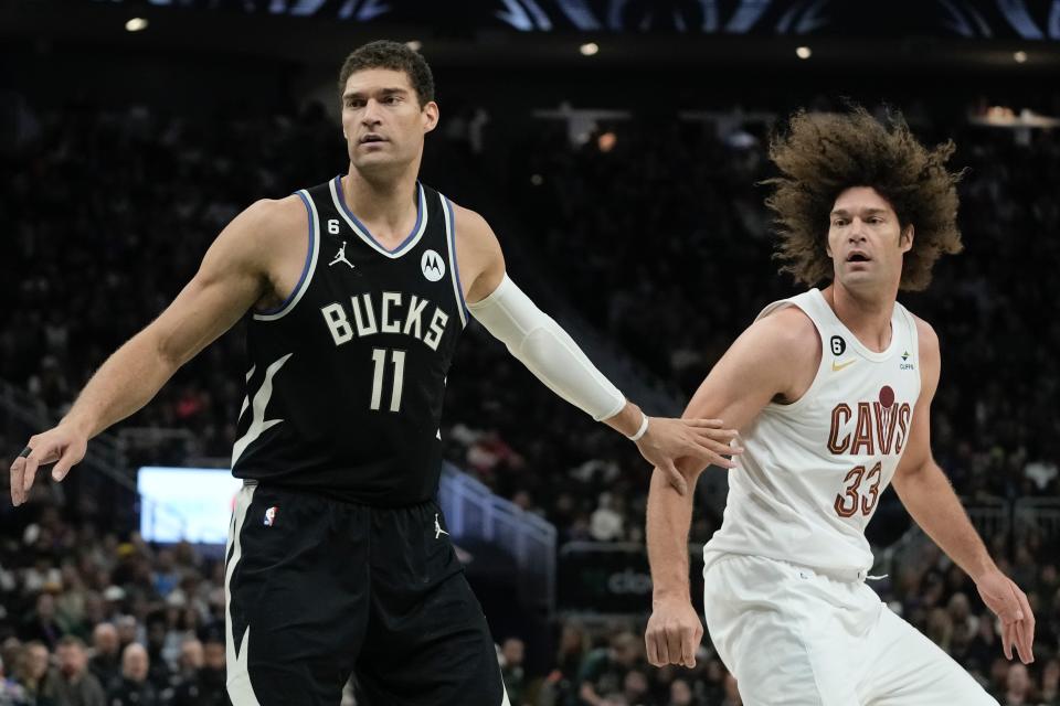 Milwaukee Bucks' Brook Lopez defends his brother Cleveland Cavaliers' Robin Lopez during the first half of an NBA basketball game Friday, Nov. 25, 2022, in Milwaukee. (AP Photo/Morry Gash)