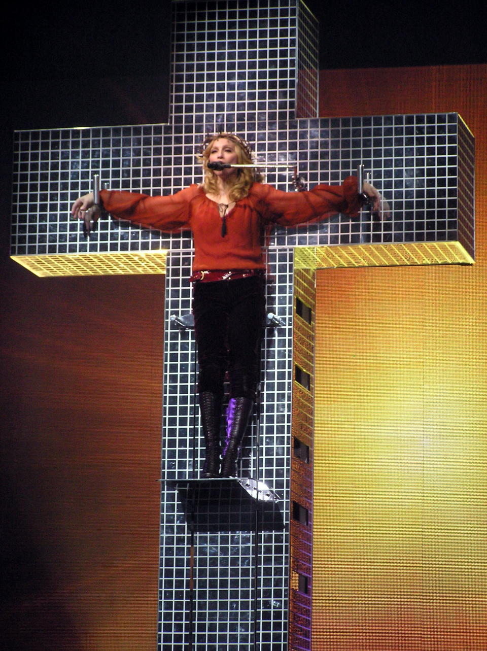 <em>May-September 2006</em>  German prosecutors threatened to sue Madonna after she performed "Live to Tell" while standing on a cross and wearing a crown of thorns on her "Confessions" Tour. 