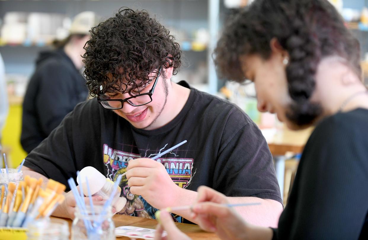 Ayden Schmucker and Gina Strain, both of Canton, visit during a outing Saturday, April 13, 2024, at Glazed and Amused pottery painting in North Canton.