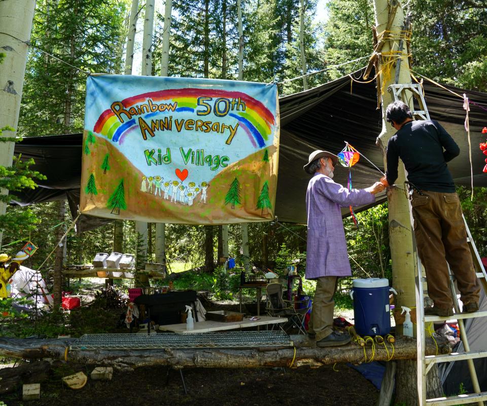 Members of the Kid Village camp at the Rainbow Family gathering set up a shade over their group kitchen in preparation for the annual campout in Routt National Forest on June 26.