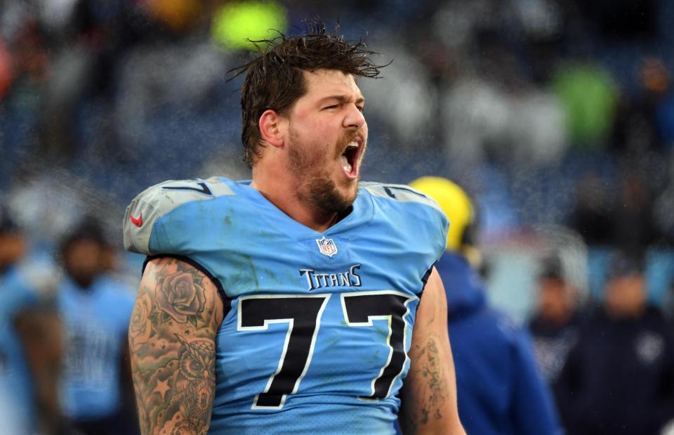 Titans offensive tackle Taylor Lewan celebrates on the sideline after a win against the Dolphins at Nissan Stadium in Nashville on Jan. 2, 2022.