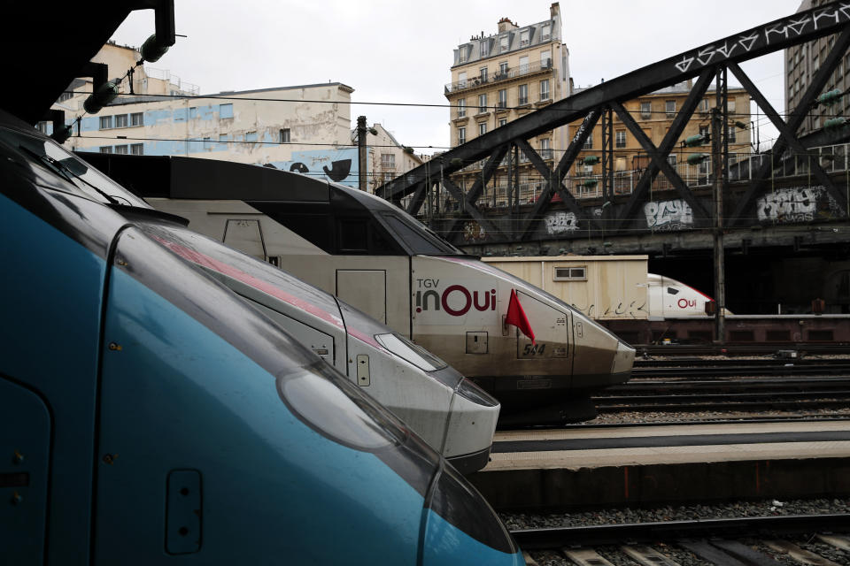 High speed trains stand bye, one of them with a red flag, at Gare de L'Est train station in Paris, Saturday, Dec. 7, 2019. French strikes are disrupting weekend travel around the country, as truckers blocked highways and most trains remained at a standstill because of worker anger at President Emmanuel Macron's policies as a mass movement against the government's plan to redesign the national retirement system entered a third day. (AP Photo/Francois Mori)