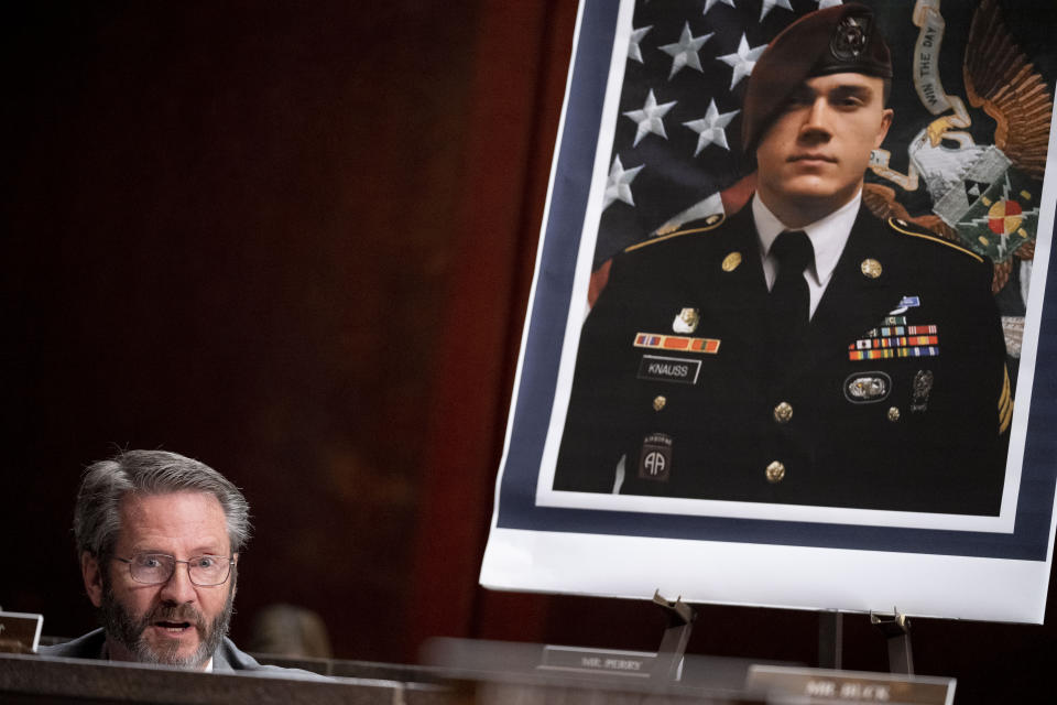 An image of Army Staff Sgt. Ryan C. Knauss, one of the members of the military killed during the withdrawal of Afghanistan, is displayed behind Rep. Tim Burchett, R-Tenn., left, as he speaks during a House Committee on Foreign Affairs hearing on the United States evacuation from Afghanistan on Capitol Hill in Washington, Wednesday, March 8, 2023. (AP Photo/Andrew Harnik)