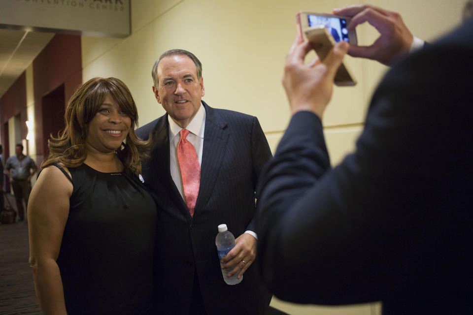 Mike Huckabee, former Governor of Arkansas and Republican U.S. 2016 presidential candidate, stands for a photograph with a guest dduring the RISE Initiative black Christian summit in Tinley Park, Illinois, U.S., on Friday, July 31, 2015.&nbsp;