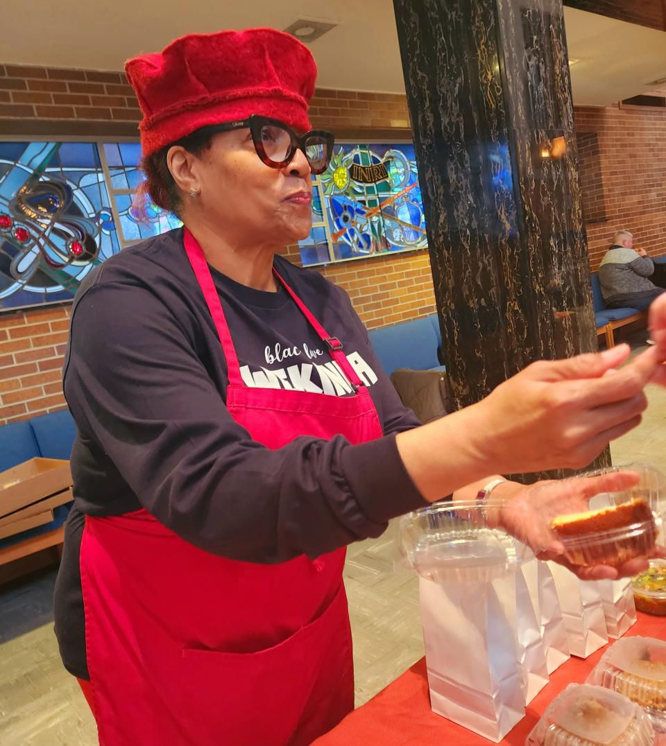 Neregin Ramsey offers a piece of her pound cake at the Milwaukee Winter Farmers Market. Ramsey sells a variety of items at the market.