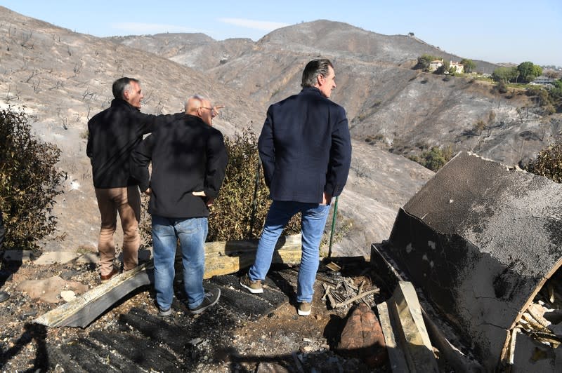 From left, L.A. Mayor Eric Garcetti, L.A. City Councilman Mike Bonin and California Governor Gavin Newsom view a burned and home along Tigertail Road in Brentwood, California