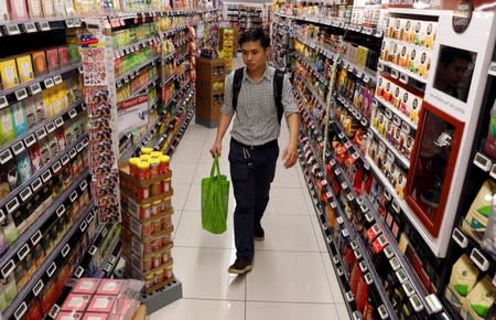 A man shops for groceries at a supermarket in Singapore