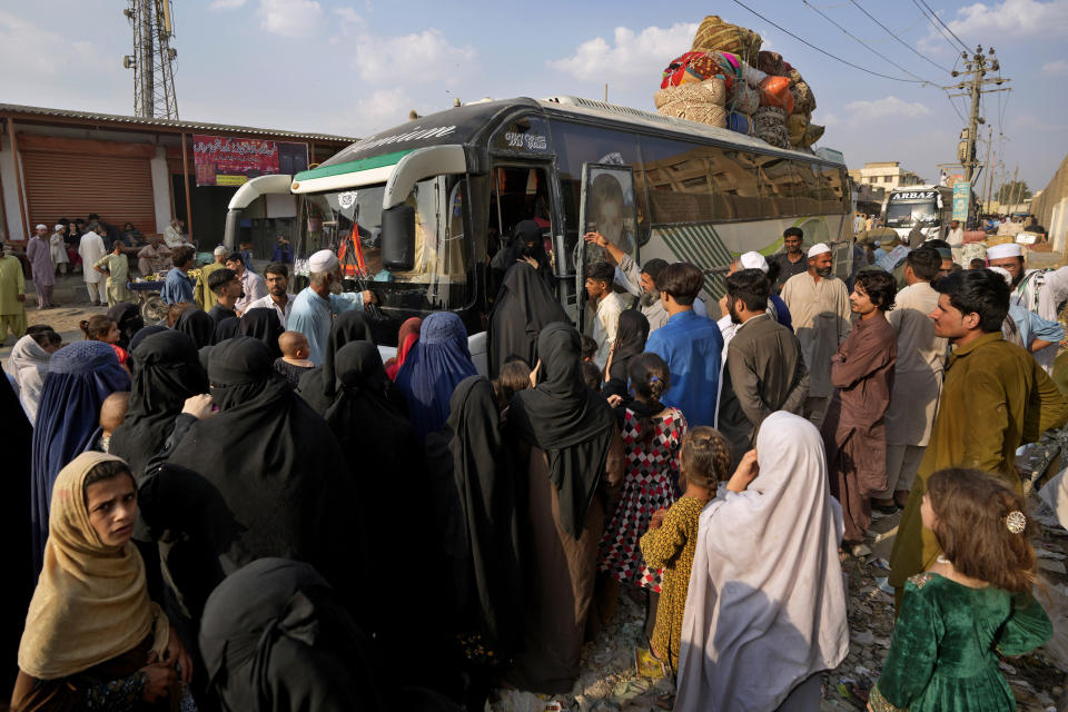FILE - Afghan families board a bus to depart for their homeland, in Karachi, Pakistan, Tuesday, Oct. 31, 2023. For more than 1 million Afghans who fled war and poverty to Pakistan, these are uncertain times. Since Pakistan announced a crackdown on migrants last year, some 600,000 have been deported and at least a million remain in Pakistan in hiding. They've retreated from public view, abandoning their jobs and rarely leaving their neighborhoods out of fear they could be next. It's harder for them to earn money, rent accommodation, buy food or get medical help because they run the risk of getting caught by police or being reported to authorities by Pakistanis. (AP Photo/Fareed Khan, File)