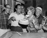 <p>Lucille takes a big bite of cake next to her costar, Bob Hope, on the set of <em>The Facts of Life</em>. That same year, Lucille and Desi filed for divorce. The actress married comedian Gary Morton a year after the divorce was finalized. </p>