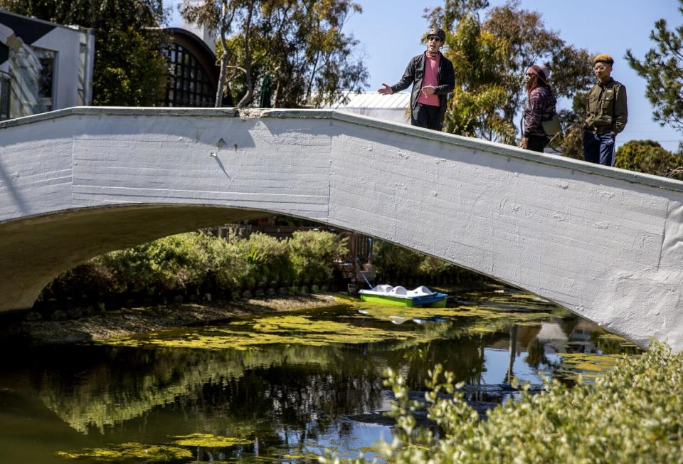 A man, left, at the Venice Canals with a woman and her son.