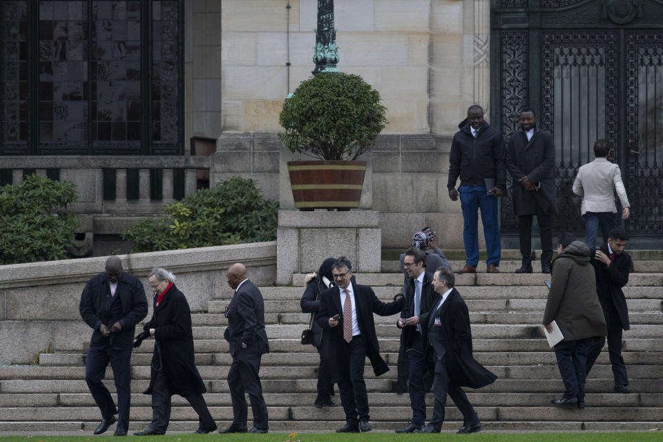 Gambia's delegation with Justice Minister Aboubacarr Tambadou, far left, leave the Peace Palace which houses the International Court in The Hague, Netherlands, Monday, Nov. 11, 2019, after filing a case at the United Nations' highest court accusing Myanmar of genocide in its campaign against the Rohingya Muslim minority. A statement released Monday by lawyers for Gambia says the case also asks the court to order measures "to stop Myanmar's genocidal conduct immediately." (AP Photo/Peter Dejong)