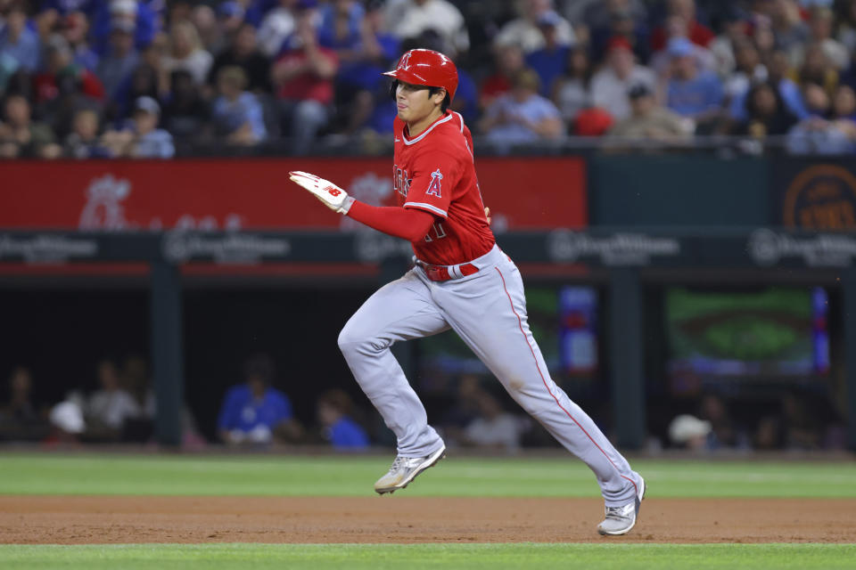 Los Angeles Angels' Shohei Ohtani sprints to second where he was forced on a Brandon Drury grounder in the third inning of a baseball game against the Texas Rangers, Tuesday, June 13, 2023, in Arlington, Texas. (AP Photo/Gareth Patterson)