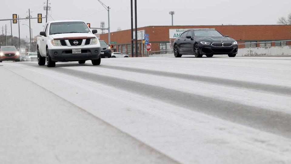 Vehicles cross an icy bridge on Montgomery Street on Monday, January 30, 2023, in Fort Worth. A winter storm warning is in effect until 6 a.m. Wednesday as mixed precipitation, primarily in the form of freezing rain and/or sleet, was expected in the area.