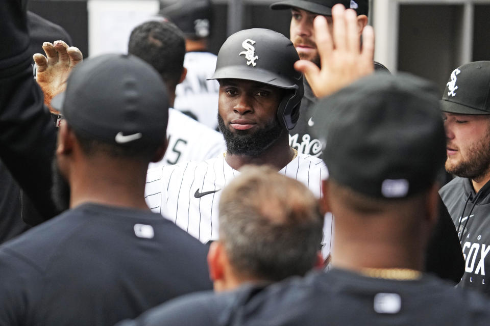 Chicago White Sox's Luis Robert Jr., celebrates in the dugout with teammates after scoring on a one-run double by Andrew Vaughn during the first inning of a baseball game against the San Francisco Giants in Chicago, Wednesday, April 5, 2023. (AP Photo/Nam Y. Huh)